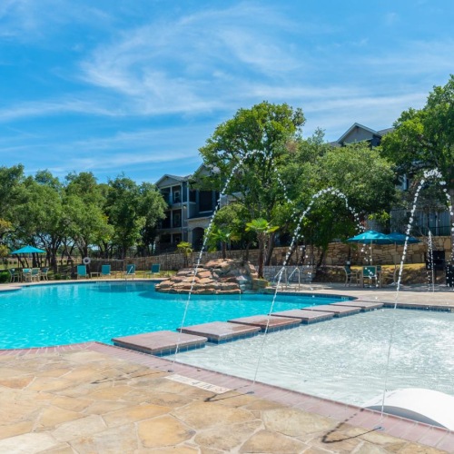 a swimming pool with a building in the background