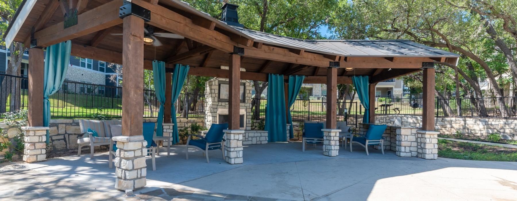 a covered patio with chairs and tables