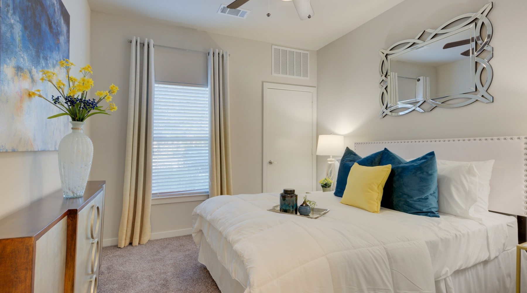a bedroom with a large mirror